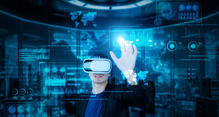 Project manager with VR goggles pointing financial chart and glowing blue light at office. Skilled...