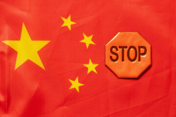 China flag and stop sign , protest and ban on background of international politics and sanctions