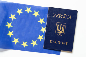 Fototapeta premium Ukrainian passport against the background of the European Union flag, the topic of citizenship, migration