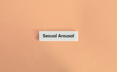 Sexual Arousal Letter Tile on Soft Pink Background – Minimalist Concept of Intimacy, Desire and Human Emotion