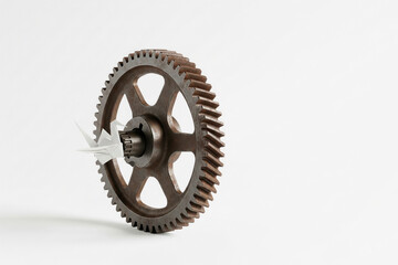 Obraz premium Paper crane in a metal gear. Space for text.