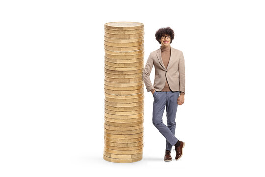 Tall young man leaning on a pile of coins and smiling