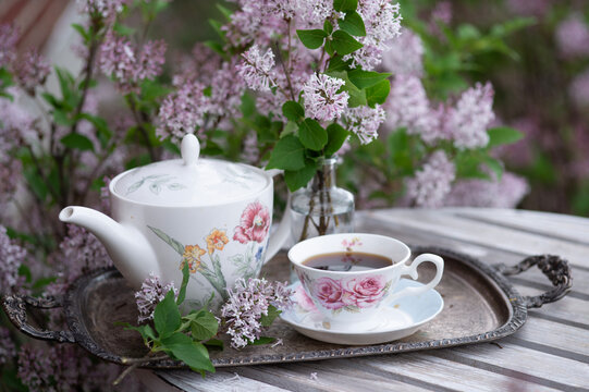 Cup of tea in picnic with lilac 