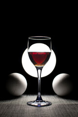 Still life with wine glass and foam balls	