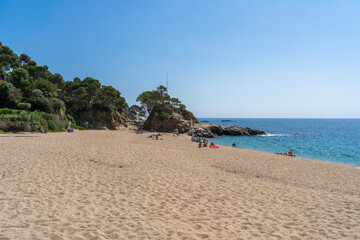 Tourists relaxing on platja de aro beach at costa brava in spain