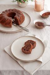 Chocolate cake with chocolate icing on white wooden table. Top view