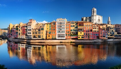 girona riverfront buildings with varied facades and reflections