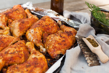 Top-down view of pub food: baked chicken drumsticks, rustic fries, sliced pickles, sauces, and beer. Cozy and casual atmosphere. Perfect for menus, blogs, or food delivery visuals