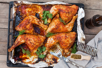 Top-down view of pub food: baked chicken drumsticks, rustic fries, sliced pickles, sauces, and beer. Cozy and casual atmosphere. Perfect for menus, blogs, or food delivery visuals