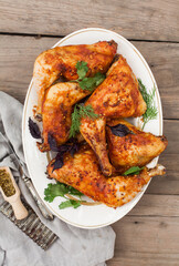 Top-down view of pub food: baked chicken drumsticks, rustic fries, sliced pickles, sauces, and beer. Cozy and casual atmosphere. Perfect for menus, blogs, or food delivery visuals