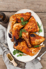 Top-down view of pub food: baked chicken drumsticks, rustic fries, sliced pickles, sauces, and beer. Cozy and casual atmosphere. Perfect for menus, blogs, or food delivery visuals
