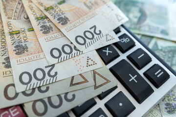 polish zloty money banknotes with calculator. 200 100 pln bills business concept