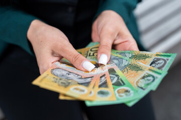 close up woman holding lot of 50 1000 new aud australian dollar. Financial concept