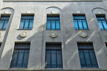 Unique building facade showcases decorative windows with distinct features
