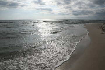 Sea waves rolling onto sandy tropical beach