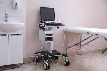 Modern ultrasound machine, sink and examination bed in clinic