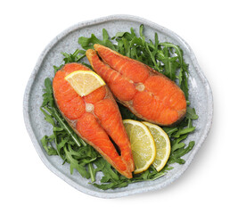 Seafood. Tasty salmon steaks, arugula and lemon isolated on white, top view