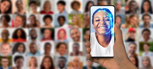 A person holds a smartphone with a face scan, surrounded by a collage of diverse portraits, emphasizing modern identification technology.