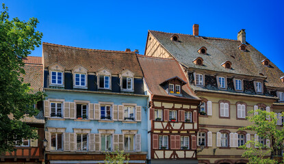 Fototapeta premium Ornate traditional half timbered houses with blooming flowers along the canals, Little Venice district in Colmar, picturesque village in Alsace France