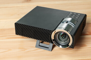 Modern video projector on wooden table, closeup