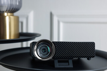 Modern video projector on black table indoors