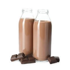 Tasty chocolate milk in glass bottles and pieces isolated on white