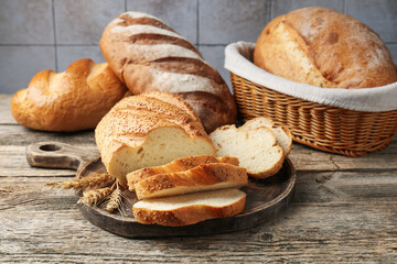 Cut bread loaf and spikes on wooden table