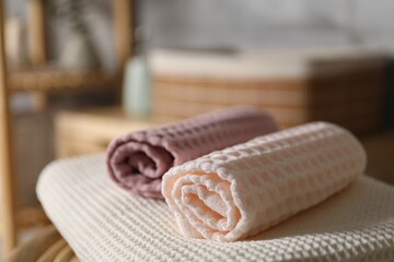 Clean waffle towels on chair in bathroom, closeup