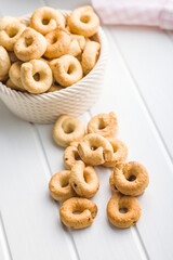 Salted crispy snack rings on kitchen table.
