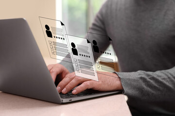 Human resources manager searching for employee on laptop at table, closeup. Resumes on virtual...