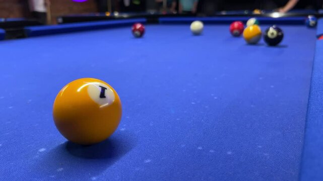 Competitive billiards match at a local pool hall featuring intense gameplay and skilled shots on a table