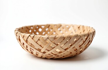 Obraz premium Empty woven wooden basket on white background. Traditional handcrafted container made from natural materials. Perfect for home decor, storing goods or food. Ideal for displaying fruit, bread on table.