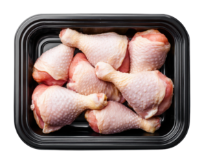 Fresh chicken drumsticks in black tray grocery store display food top view isolated on transparent background