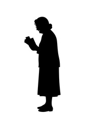 Elderly woman reading a book while standing in silhouette  