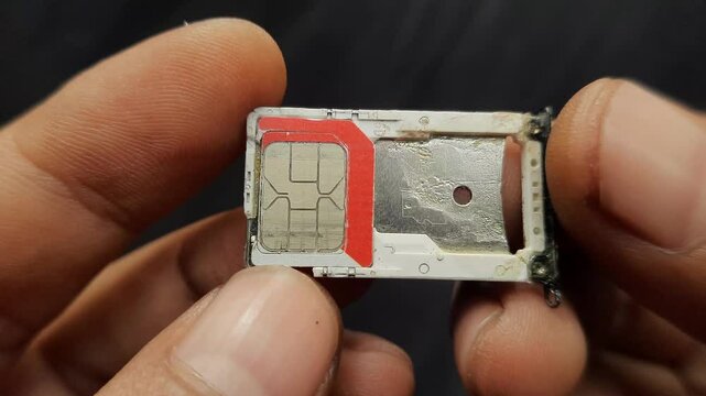SIM Card Held by Hand in Macro Shot