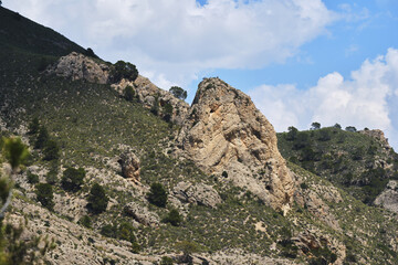Majestic rocky hill landscape with lush greenery and dramatic sky