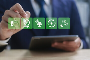 Energy efficiency concept, Energy efficient house building rate label audit. Businessman touching...