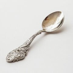 Ornate Silver Spoon with Intricate Design on a Plain Background