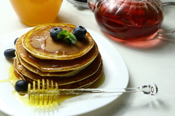Tasty homemade pancakes with honey and berries