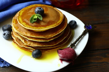 Tasty homemade pancakes with honey and berries