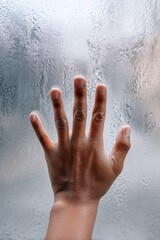 Portrait of a hand pressed against transparent glass covered in condensation, isolation, vulnerability, unseen stories, mental health symbol