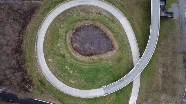 Steady topdown droneshot of cyclists using a bicycle loop. 