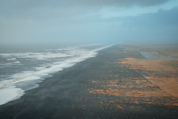 Visitors exploring Reynisfjara volcanic black beach