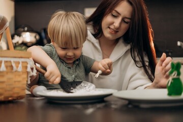 Emotional bonding moment as mother and toddler enjoy flour play in kitchen exploring spring rituals mindful connection and homeschool-inspired creativity through textures rhythm and shared attention