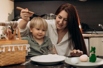 Creative parenting meets indoor Easter fun as toddler explores flour with sensory play joyful learning and family traditions in a cozy kitchen moment of bonding mess and heartwarming spring connection