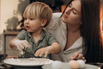Toddler explores flour with mother watching gently capturing warm childhood memories family bonding through sensory kitchen play mindful parenting and calm slow living connection at home