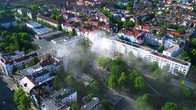 Rescue helicopter landing in Berlin urban park. Smooth aerial view flight drone