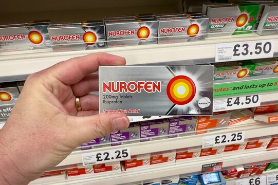 Chelmsford, UK - May 12, 2025: A box of Nurofen ibuprofen pain relief tablets being selected from a supermarket shelf in the UK. 
