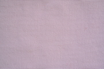 pink texture of knitted synthetic fabric as a background, pink smooth symmetrical lines of synthetic fabric