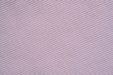 pink texture of knitted synthetic fabric as a background, pink smooth symmetrical lines of synthetic fabric